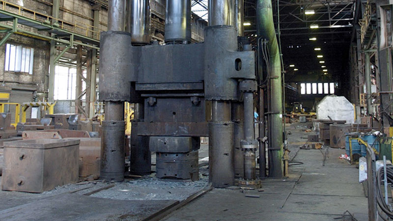 An industrial-sized forge in the center of a factory.