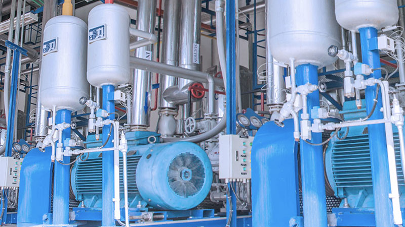 Industrial compressors operating in a facility.